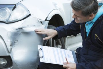 the officer checked the car damage cause by the accident