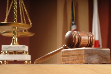 Justice scale and gavel inside the courtroom.