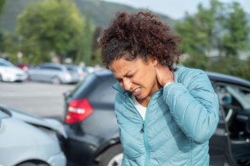 woman holding her neck after a car accident