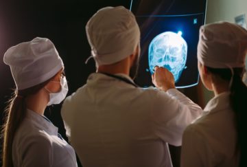 Doctors examining a patient's x-ray.