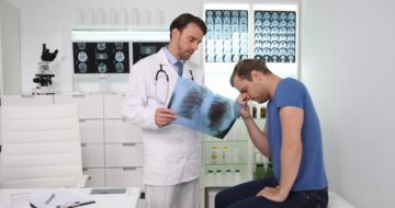 Doctor explaining cancer xray results to patient.