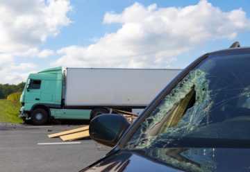 Car and truck accident happening along the road.