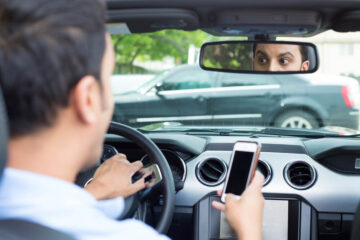 Driver using phone while driving.