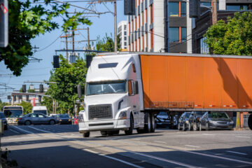 Orange truck turning left.