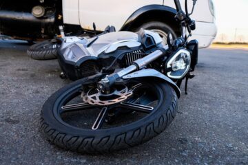 Motorcycle fell down on the road due to accident.