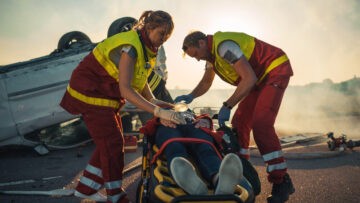 Paramedics rescuing rollover accident injured victims.