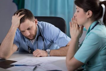 Worried doctors on the misdiagnosis of a patient.
