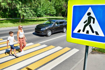 Mother and child crossing in the pedestrian lane.
